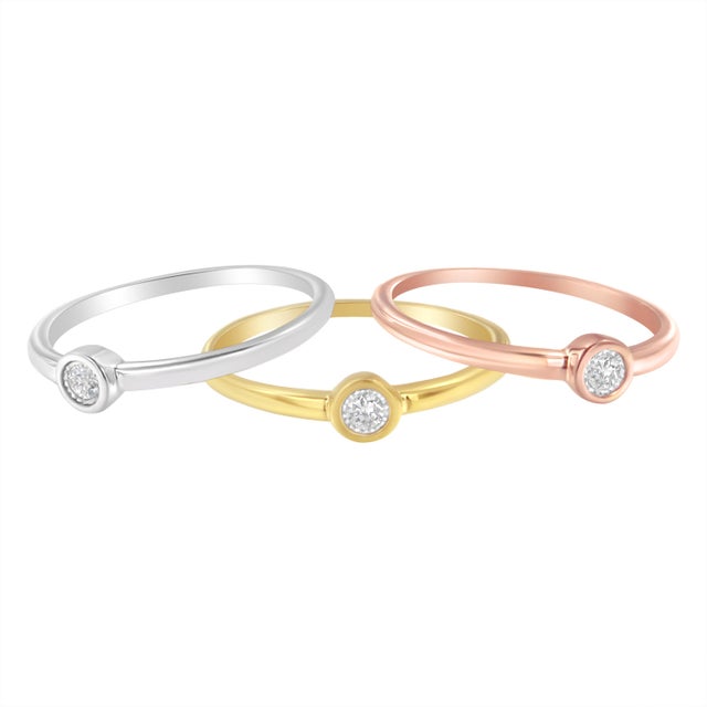A promise ring crafted in yellow, white, and rose sterling silver that is micron 2 plated with 14 karat gold and featuring...
