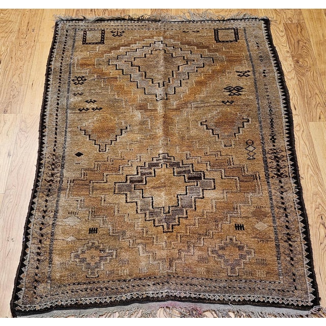 This vintage Moroccan camel hair area rug, woven during the second quarter of the 20th century, exemplifies the timeless...