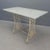 This marble-topped garden table features a durable cast iron frame, combining timeless elegance with robust construction....