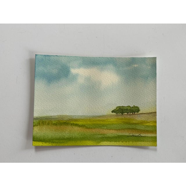 A stand of trees in the distance. Signed watercolor, ready to frame. Nancy Smith studied art at Kalamazoo Institute of...