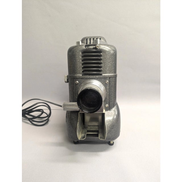 A 1950s La Belle Model 500 vintage slide projector. The vintage slide viewer has a durable build with a metallic exterior....