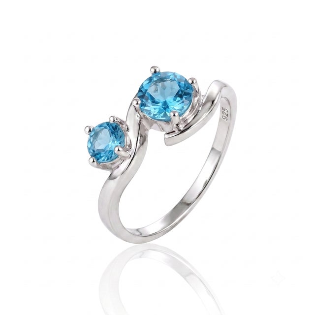 Inspired by rolling ocean waves, this striking dual-stone ring wraps bright blue gems in a polished swirl, perfect for...