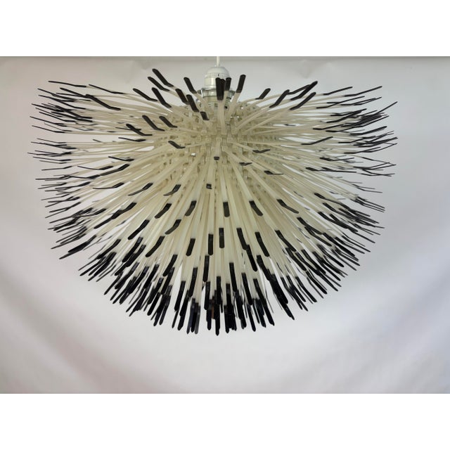 Claire Norcross. '850' ceiling light, 1999. The lamp is made by Habitat, London and made of Cable ties in white and black....