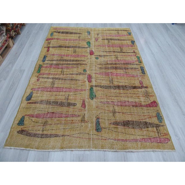 This is a vintage yellow rug from the Oushak region of Turkey. The piece is approximately 50-60 years old.