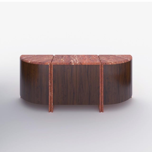 A credenza inspired by giant water lily pads and their curled rims, handmade out of 30 mm thick honed unfilled red...