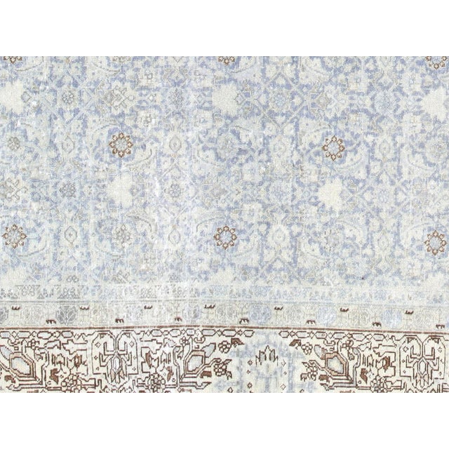 This lavish hand-knotted Persian Tabriz rug adds the perfect touch of elegance to any space. Its intricate design features...