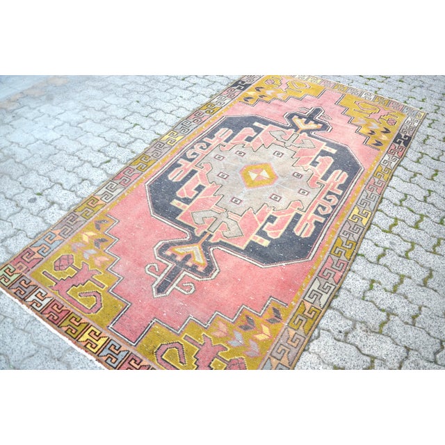 This is a vintage Turkish Oushak rug from the 1960s. The piece was hand-knotted.