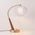 The Boomerang Table Lamp is a Modern table lamp in NOVA's lighting line, featuring a Dark Walnut/Weathered Brass steel...