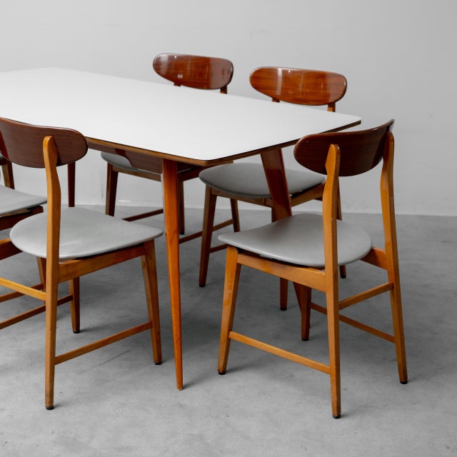 Rectangular wooden dining table with glass top. Six brown wooden chairs with gray seats. The dining set is in excellent...