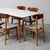 Rectangular wooden dining table with glass top. Six brown wooden chairs with gray seats. The dining set is in excellent...
