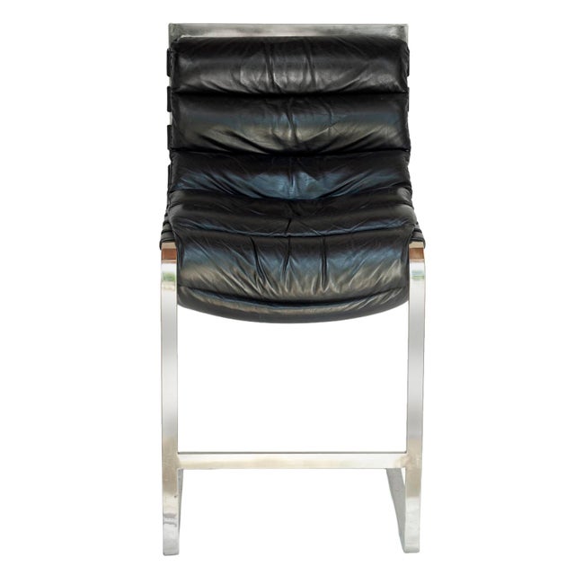 A Vintage Pair of Restoration Hardware Black Leather & Chrome Bar Stools brings the sexy Industrial vibes.