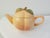 Charming pair of nicely matched ceramic figural peach handled teapots. Larger pot, (11"L x 6"W x 6.5"H), holds 32 ounces,...
