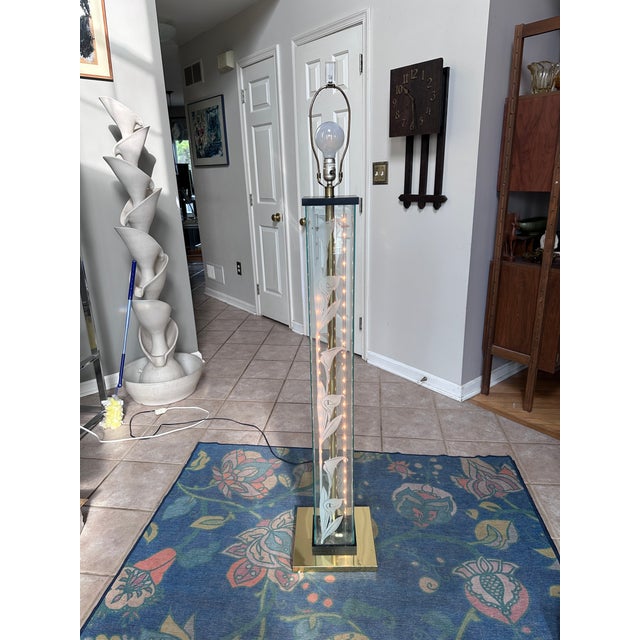 A graceful vintage floor lamp inspired by the elegant floral lighting designs associated with Frederik Raymond. This...