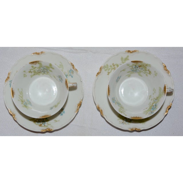 Delicate blue flowers with greenery surround this dainty set of porcelain and features accents of gold on the rims. This...