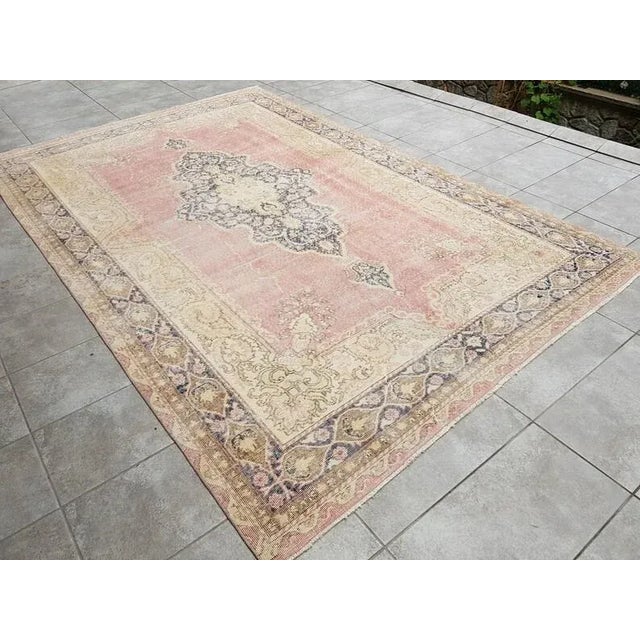 A Turkish handmade vintage Anatolian Oushak rug. We collect old vintage antique rugs from Anatolia, which is the eastern...