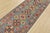 A tribal Caucasian Kazak runner hand-knotted with fine wool on a cotton foundation. This rug features a row of geometric...