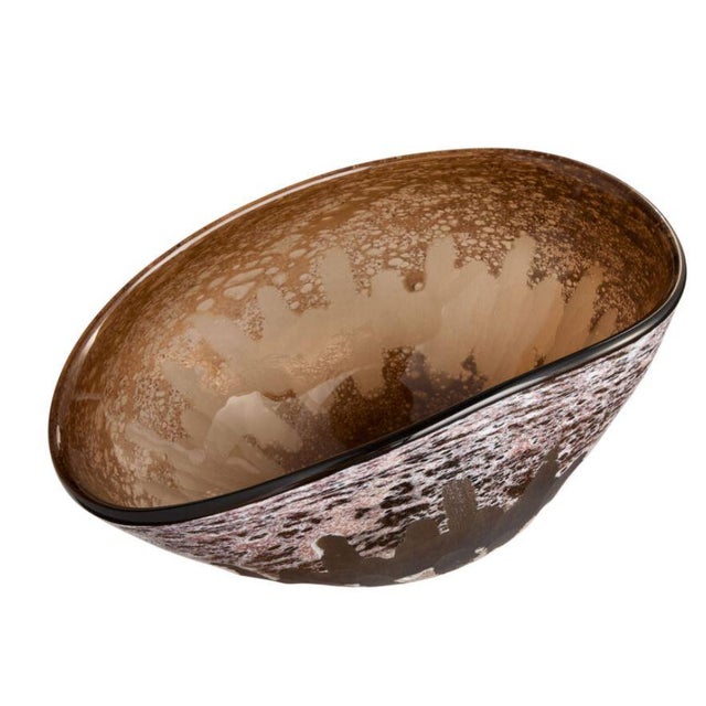 The Callisto Vase’s reactive finish creates a mesmerizing blend of rich amber and brown hues. This finishing process...