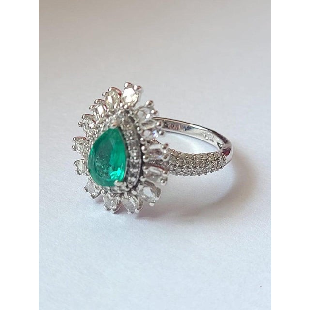 A very beautiful and one of a kind, Emerald Engagement Ring set in 18K White Gold & Diamonds. The weight of the Emerald us...