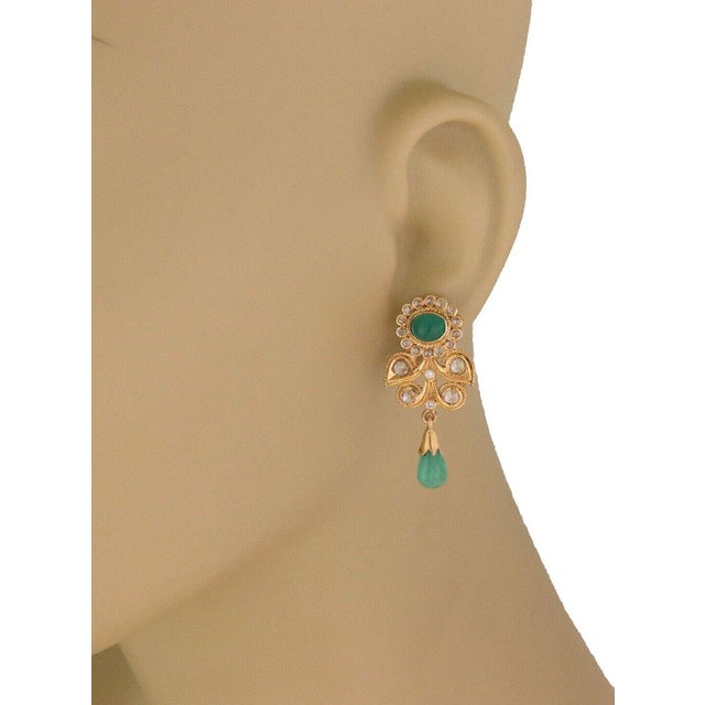 This stunning pair of earrings are crafted from 21k yellow gold and has 18k gold posts and backs. The oval shaped top has...