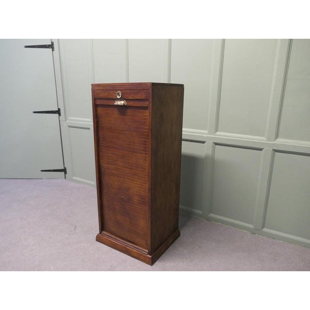 This is an attractive piece it has 8 sliding shelves The front of the Filing cabinet is good and free moving, the tambour...