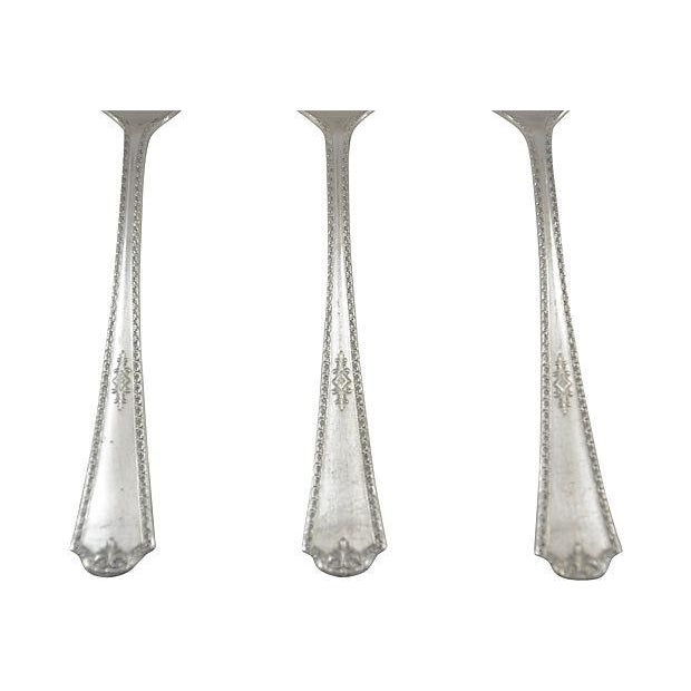 A set of three vintage silverplate serving spoons, circa 1930. Marked "Peerless Silverplate.” Light wear and patina.