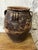 Large hand-thrown earthenware jar with four handles, a globular body, wide everted rim, and two small vertical loop...