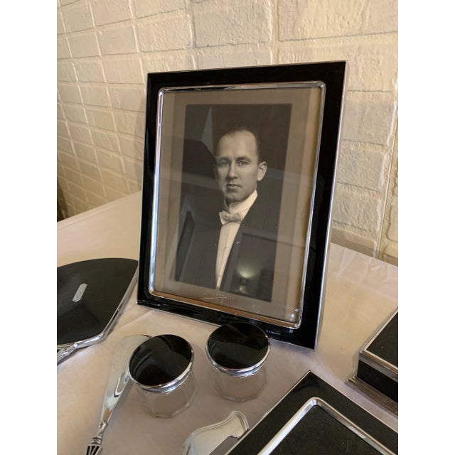 Extraordinary stainless steel and enamel vanity set including frame, dresser tray, manicure pieces, make-up pieces,...