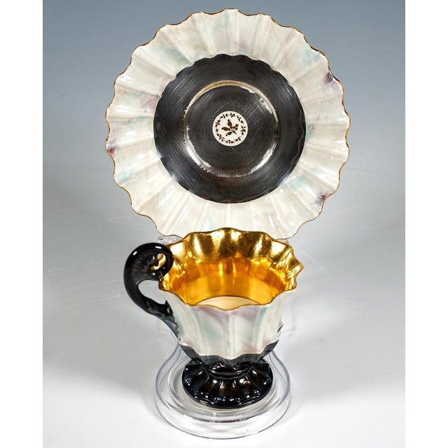 Finely decorated porcelain cup with saucer: Bell-shaped, flared cup on a stepped foot, with a fully ribbed wall, the upper...