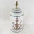 This sophisticated vintage hand-painted tole table lamp features a classic cylindrical tea caddy silhouette in a crisp...