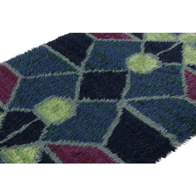 Hand-knotted in lush, high-pile wool in Sweden circa 1960-1970, this 4x6 vintage Swedish Rya rug is a bold new addition to...