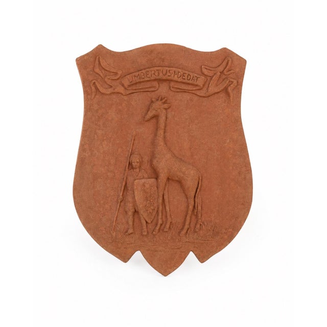 Crafted in warm terracotta, this classical Italian wall plaque showcases the historic heraldic coat of arms of the...