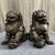 A striking pair of large Chinese Cloisonné enamel Buddhist lions (foo dogs). Each figure is seated on its haunches, with...
