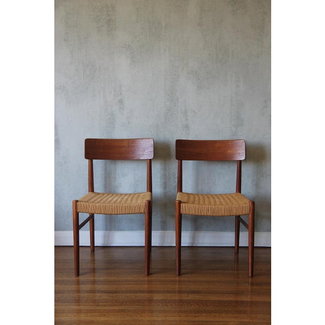 Set of 4 Danish chairs in teak with braided seats made of waxed cardboard cord. The seats are meticulously hand-laced with...