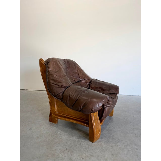 Vintage 1970’s Belgian Brutalist Oak and Brown Leather Lounge Chair, maker unknown. Solid oak frame with paneled sides and...