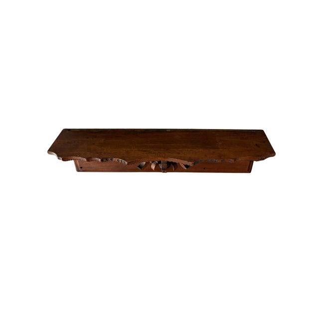An authentic Victorian-era wall shelf crafted from solid walnut and featuring beautifully detailed hand-carved...