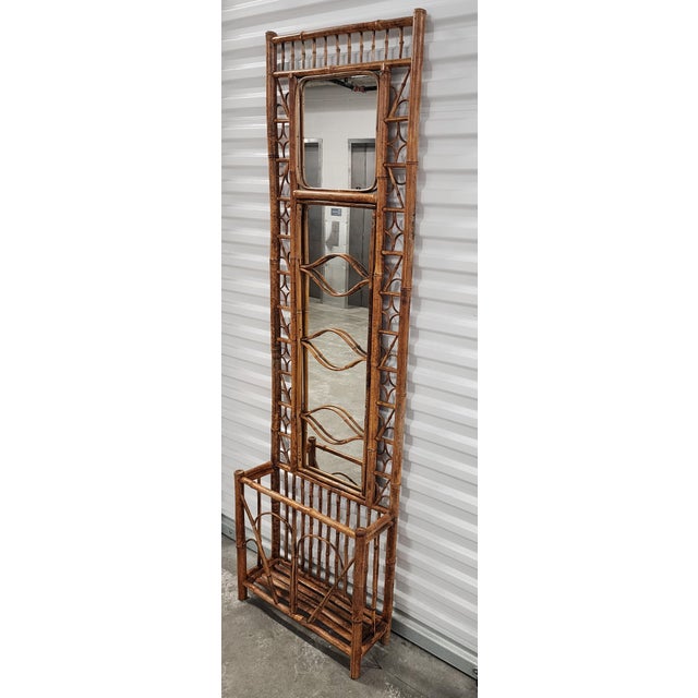 Mid Century tortoise bamboo & rattan Hall Tree with tall mirror and umbrella stand. The Hall Tree features intricating...