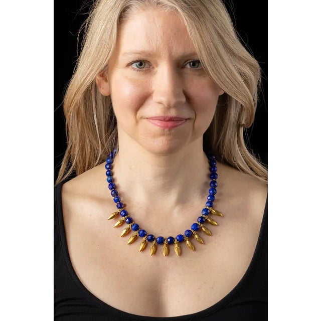 A fabulous beaded necklace with round faceted, natural lapis lazuli interspersed with 22K gold spears from India with fine...