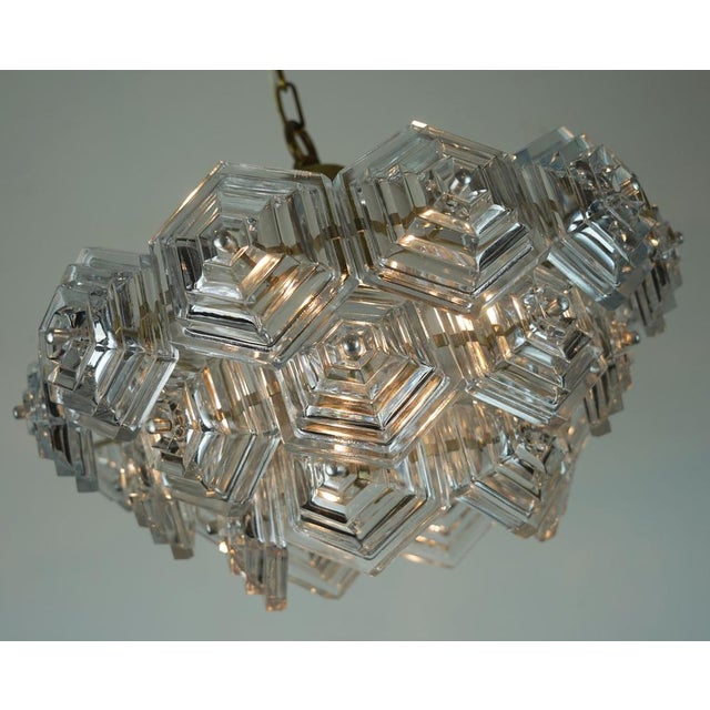 Beautiful vintage glass chandelier / pendant lamp dating from the 1960s–70s, featuring 27 hexagonal glass panels arranged...