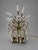 A decorative table lamp attributed to Maison Jansen, probably mid-20th century, combining brass and gold-finished metal...