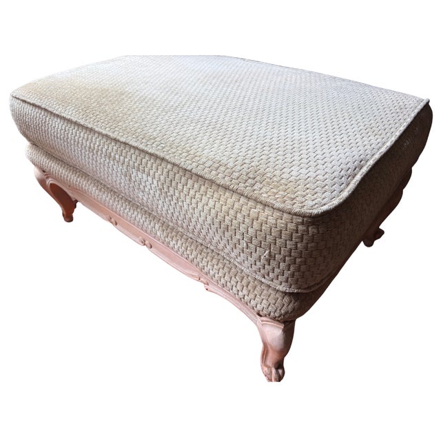 A generously scaled and beautifully appointed Louis XV style ottoman with a carved cream painted hardwood frame. The...