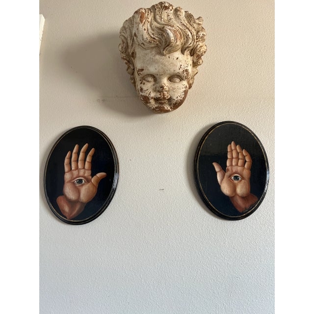 Pair of old masters manner hand painted mystical oval paintings/pair, depicting two hands with eyes on the palms. oil on...