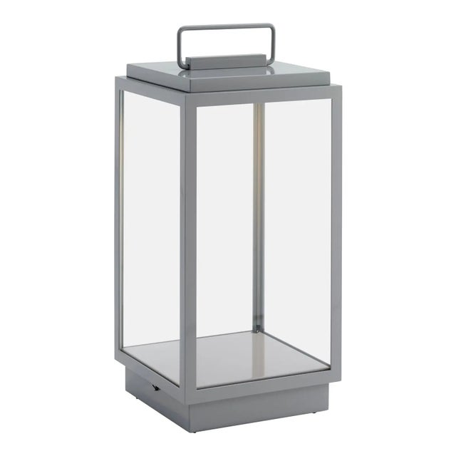 Eclectic table lamp in bronze lacquered in color with inside fitted glass. Supplied with rechargeable Li-ion battery at...