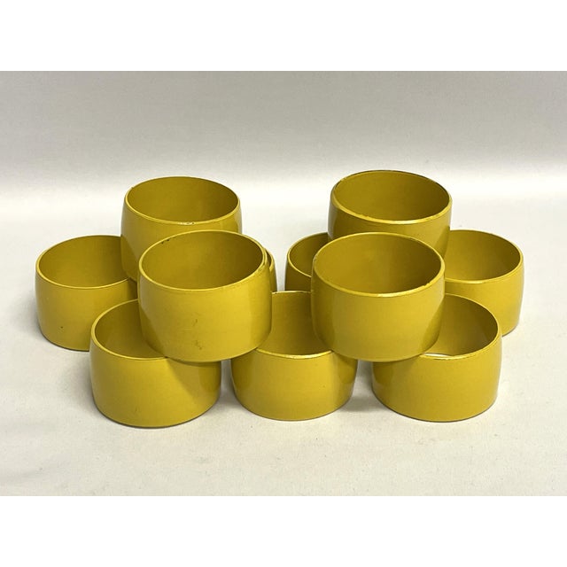 A set of eleven mustard yellow napkin rings, made in Japan. The vintage melamine will add color and charm to your table.