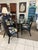 Vintage McGuire bamboo black table with newly lacquered black reed chairs to enhance the palm beach regency style....