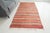 This is a vintage Turkish Oushak rug from the Mid 20th Century. The piece was hand-knotted.