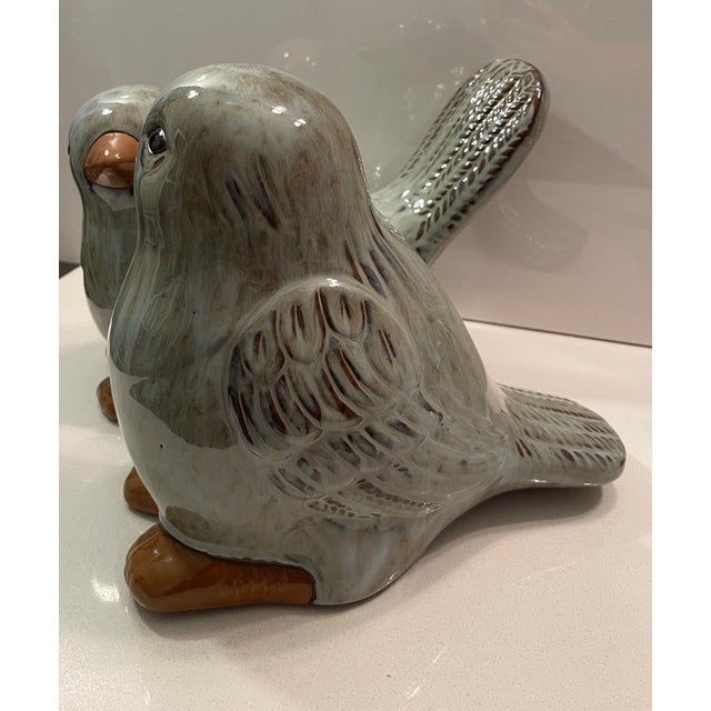 This is a lovely pair of conjoined birds ceramic sculpture. There are two (intentional) round circular holes, one on the...