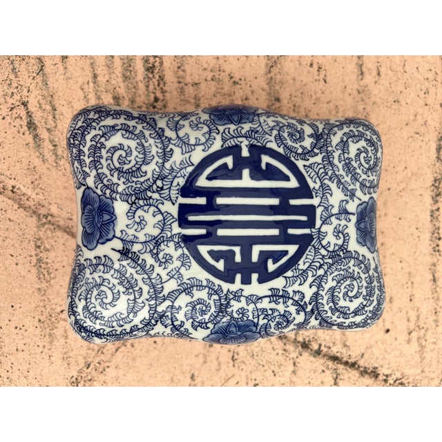 This item is a decorative lidded porcelain box featuring a traditional "Double Happiness" symbol and blue floral vine...