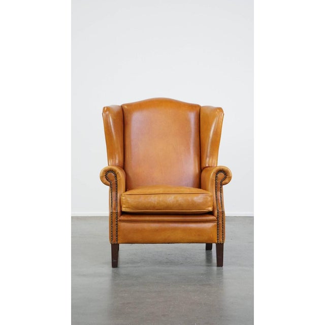 This beautiful, comfortable, luxurious cowhide leather wing chair, finished with decorative nails, in good condition. This...
