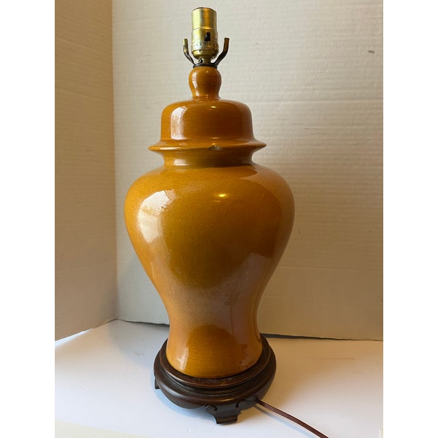 A single vintage ceramic ginger jar form table lamp mounted on a carved wood base. Height measured to top of socket.