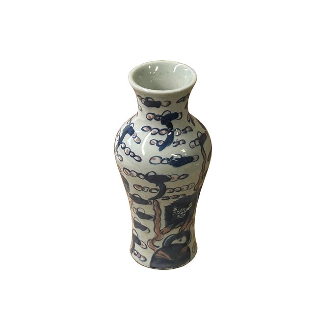 This elegant porcelain vase features a classic baluster form, showcasing a vibrant hand-painted scene of Buddhist Lions,...